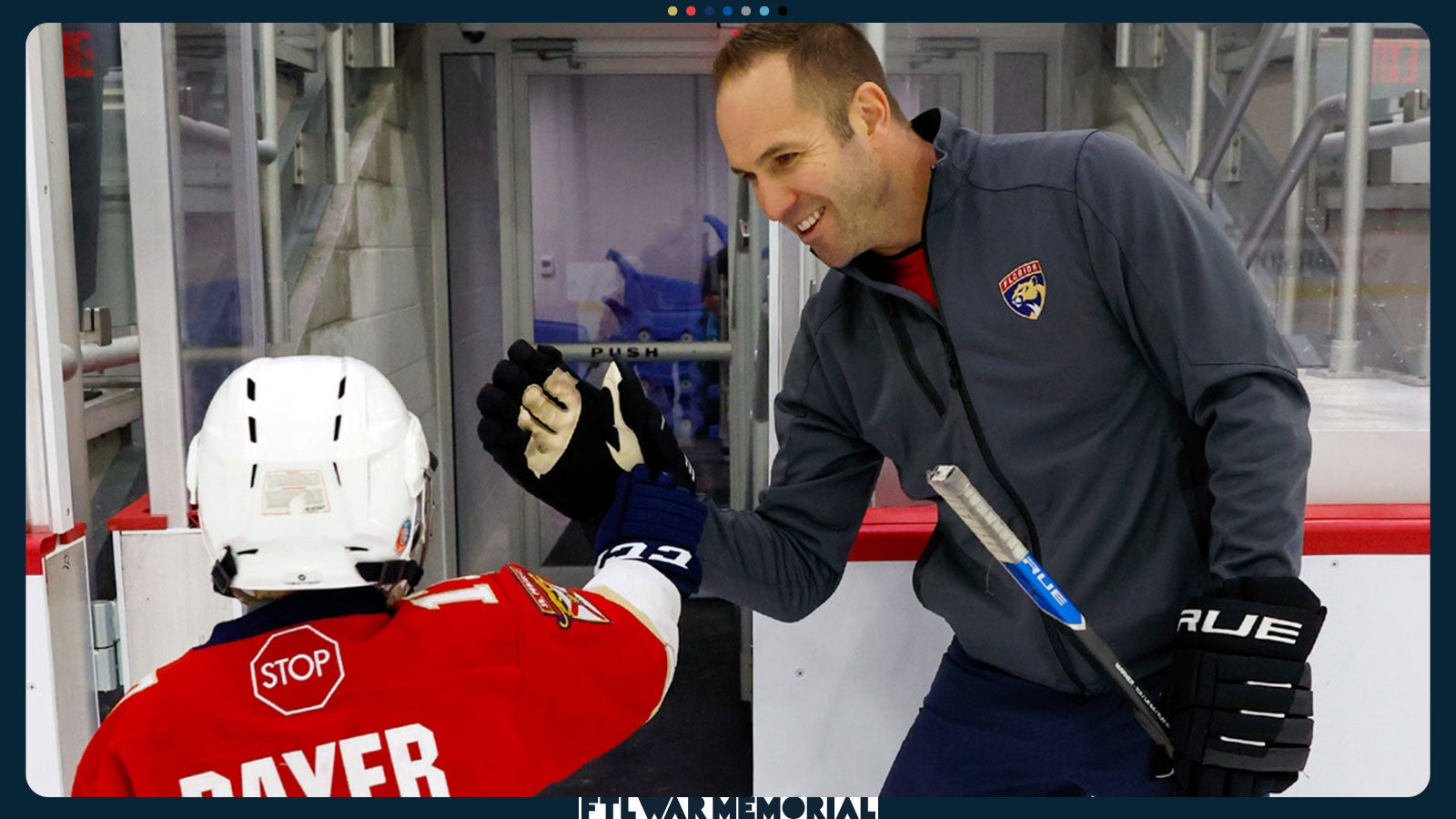 Child hockey player and coach high-fiving